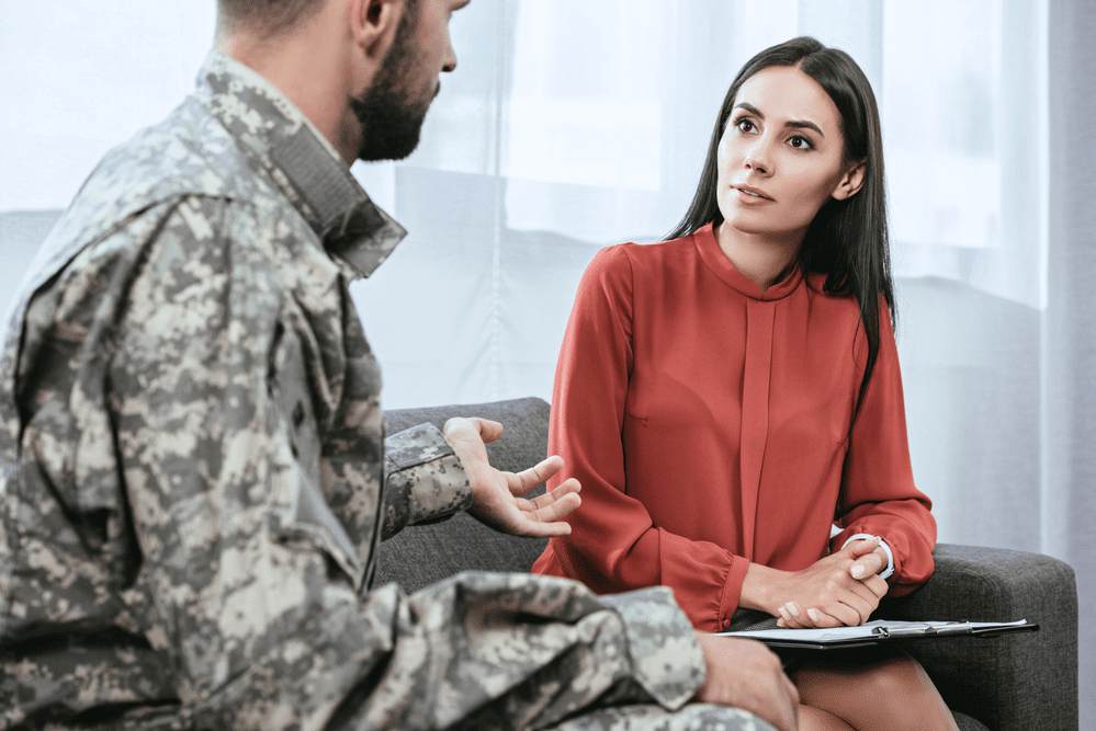 A mental health professional talks with a soldier about his PTSD 