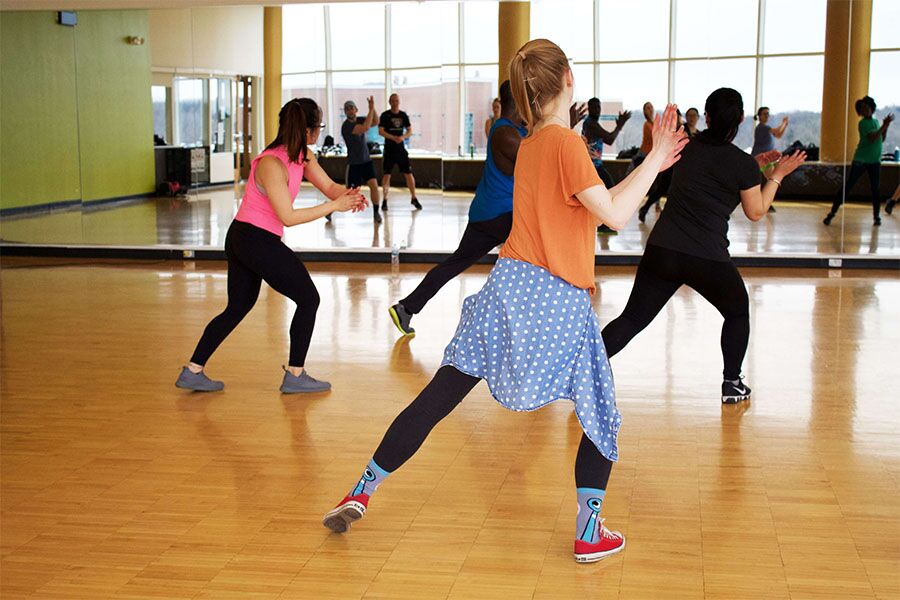 a group of people following a certified therapeutic recreation specialist at Transformations Mending Fences as they engage in recreation therapy dance classes to improve physical and mental health