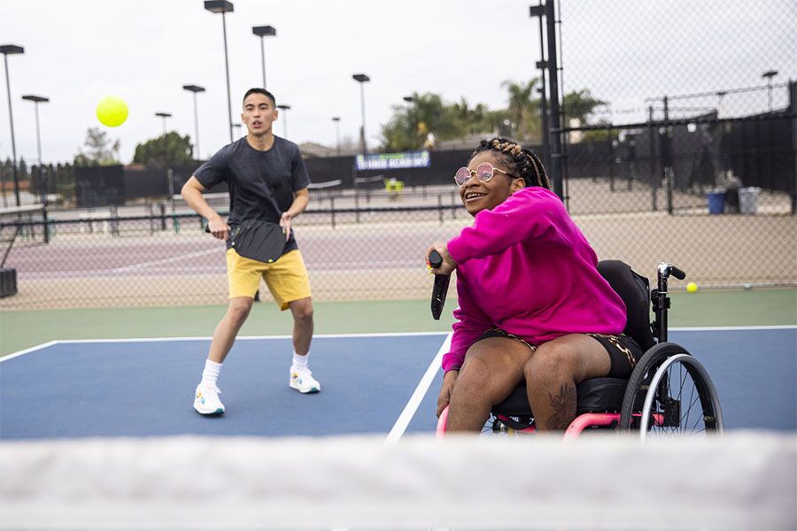 a woman in a wheelchair participating in recreational therapy with certified therapeutic recreation specialists to improve psychological and physical health