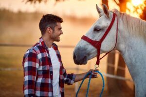 A veteran with posttraumatic stress disorder engaging in equine-assisted psychotherapy at Transformations Mending Fences